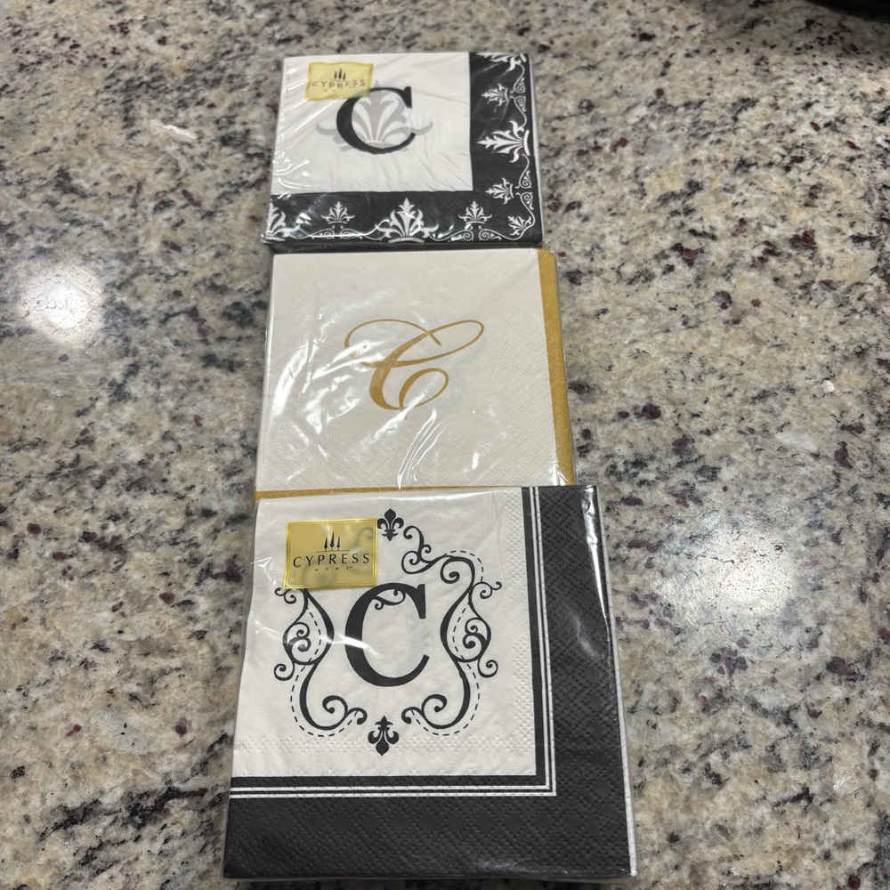 3 sealed packs of “C” cocktail napkins 2 black/white 1 gold/white